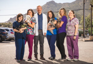 Desert Forest Animal Hospital veterinary team with pets outdoors in Cave Creek, Arizona